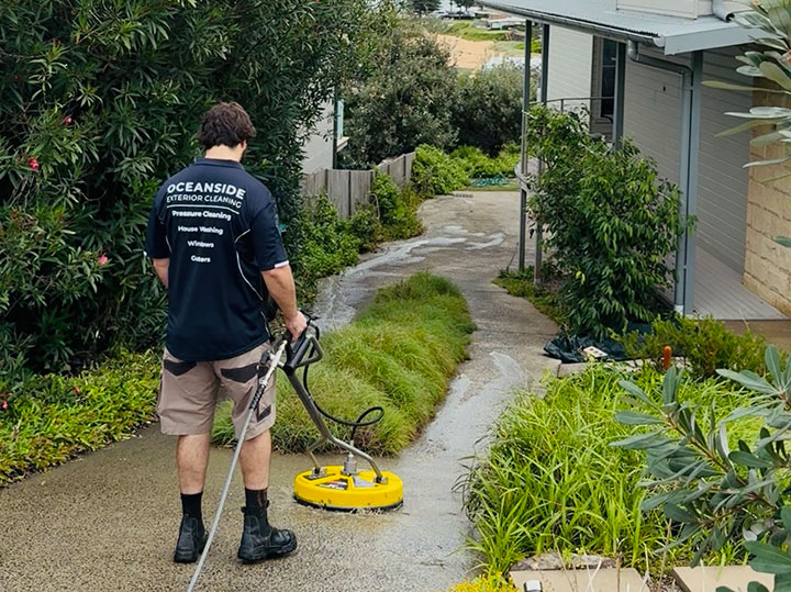 Oceanside Exterior Cleaning team member cleaning an exterior surface